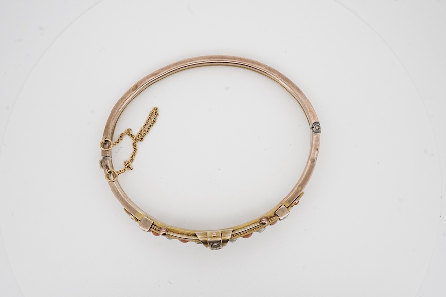 A Victorian yellow metal, split pearl and split coral set hinged bracelet, interior diameter 58mm, gross weight 9.1 grams. Condition - poor
